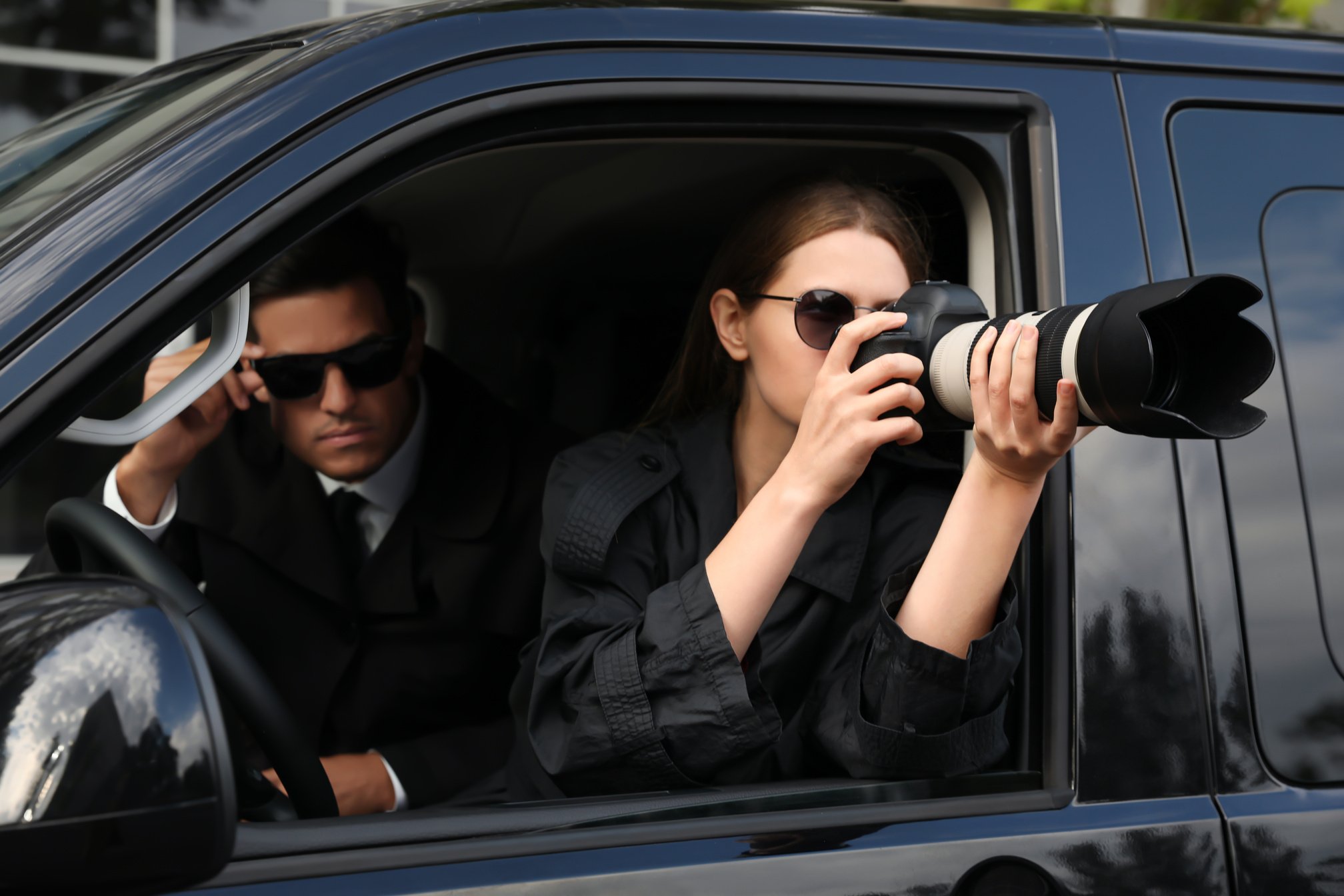 Private Detectives with Modern Camera Spying from Car